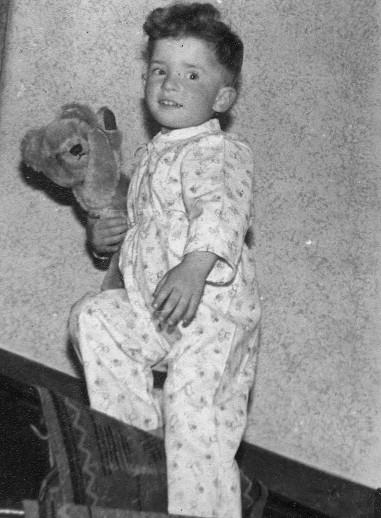 small boy holding teddybear