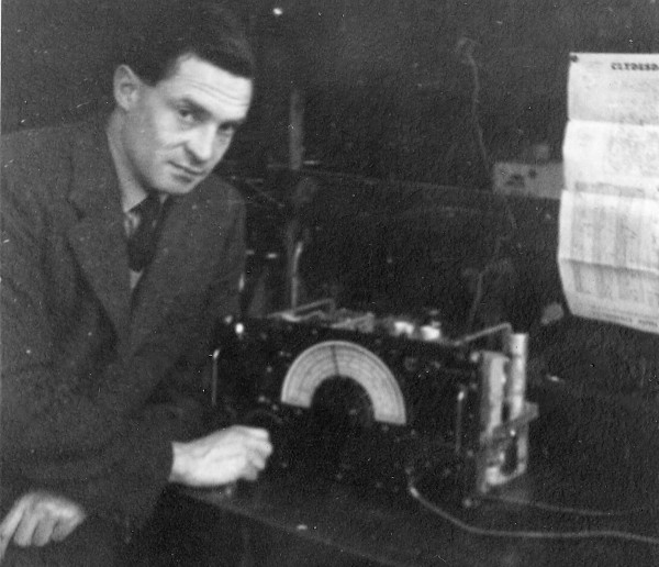 man adjusts radio on workbench