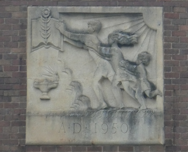 large carving set into brickwork